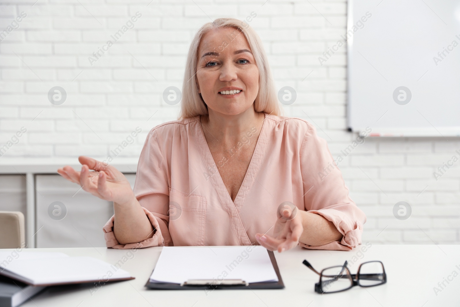 Photo of Mature woman using video chat in office, view from web camera