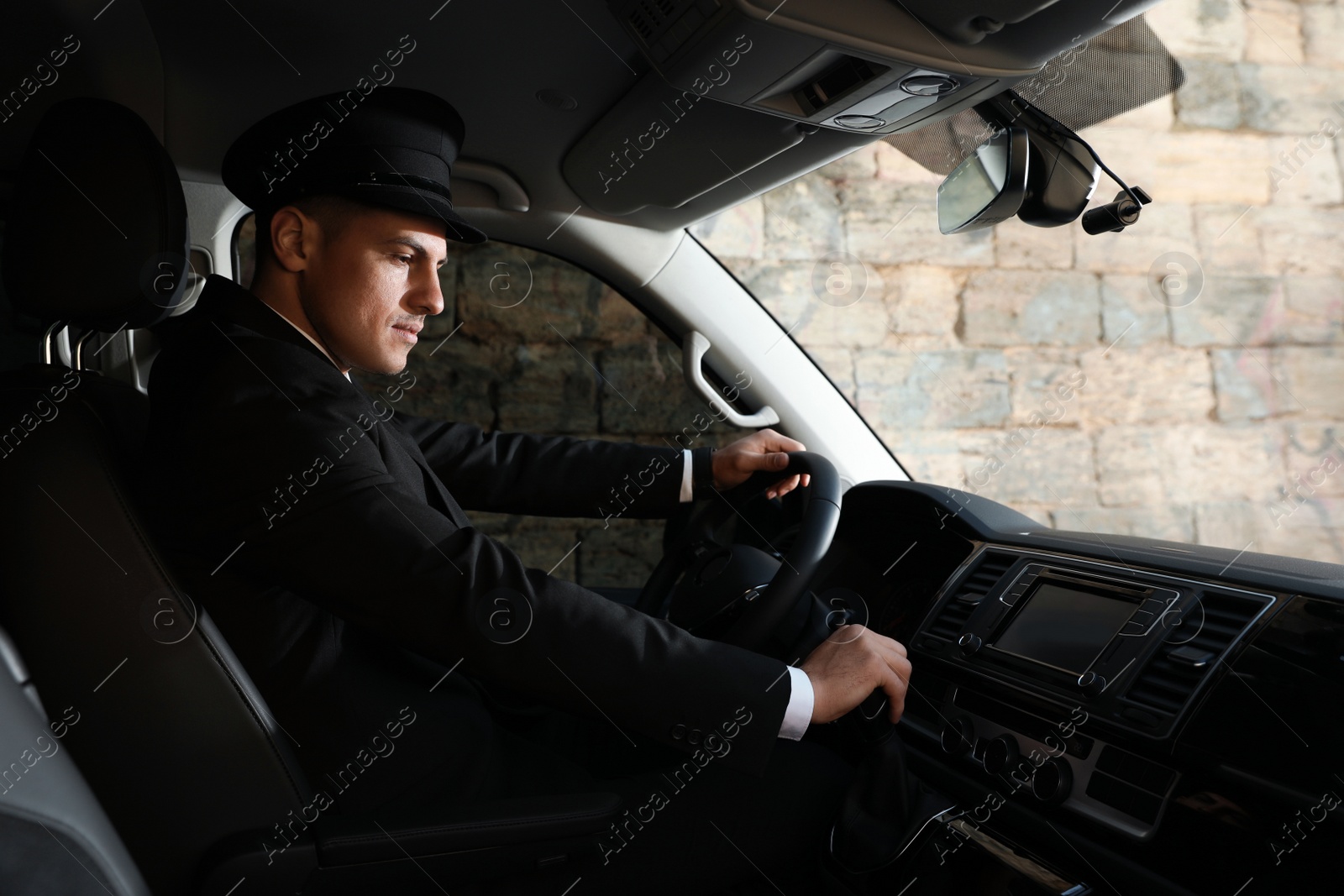 Photo of Professional driver in luxury car. Chauffeur service