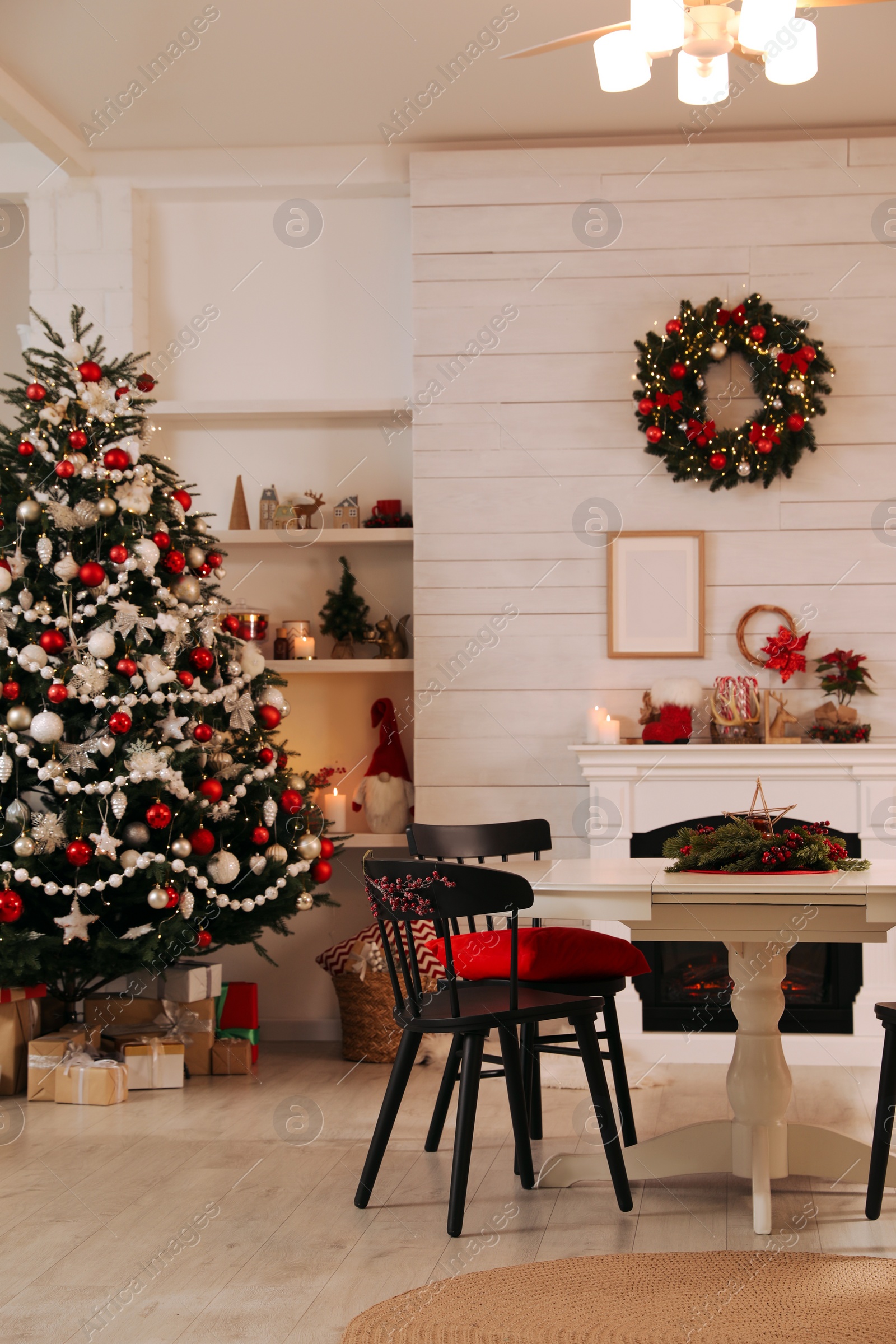 Photo of Cozy dining room interior with Christmas tree and festive decor