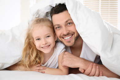 Photo of Dad and daughter spending time together at home. Happy Father's Day