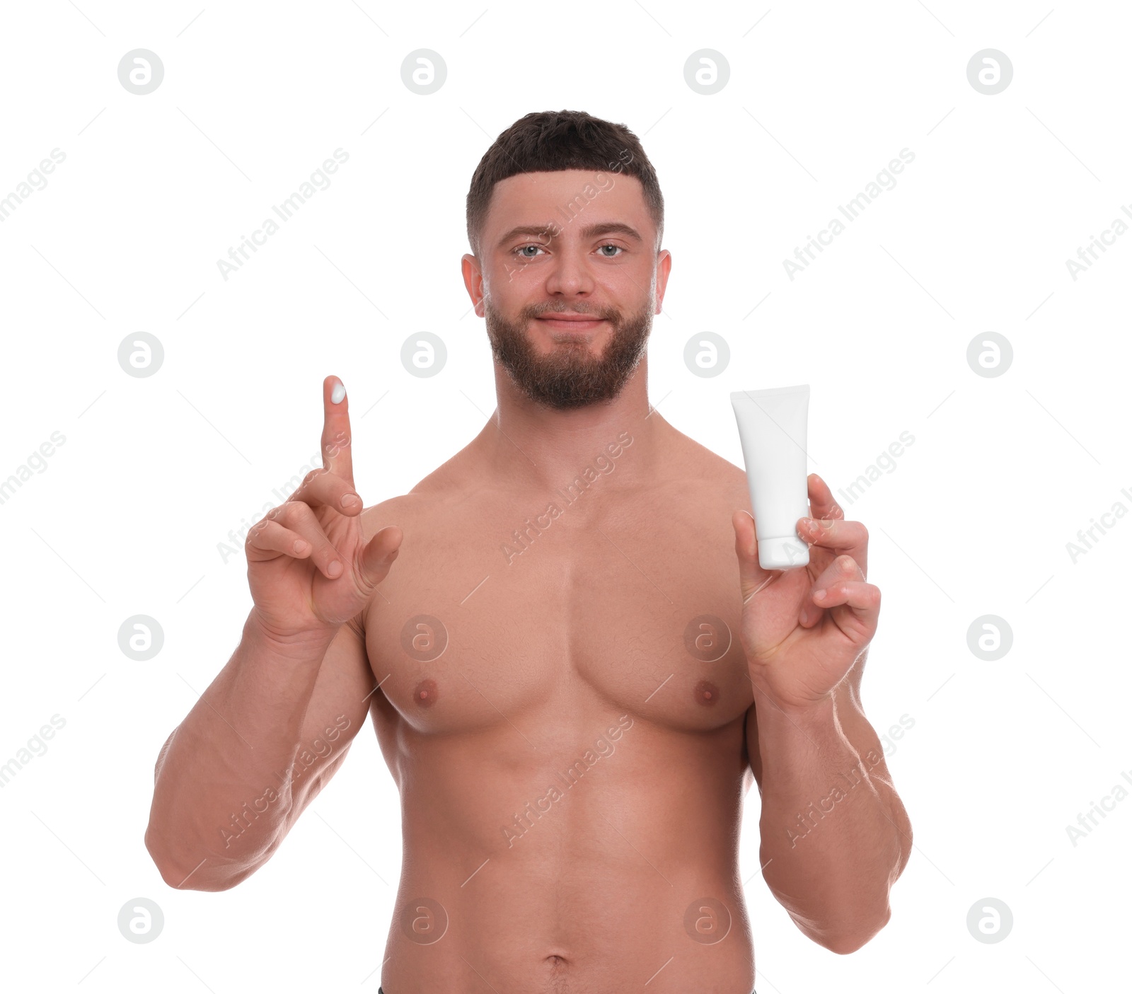 Photo of Handsome man with tube of body cream on white background