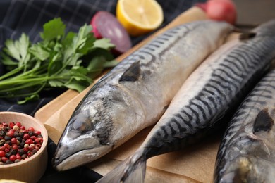 Photo of Tasty salted mackerels and spices on table, closeup