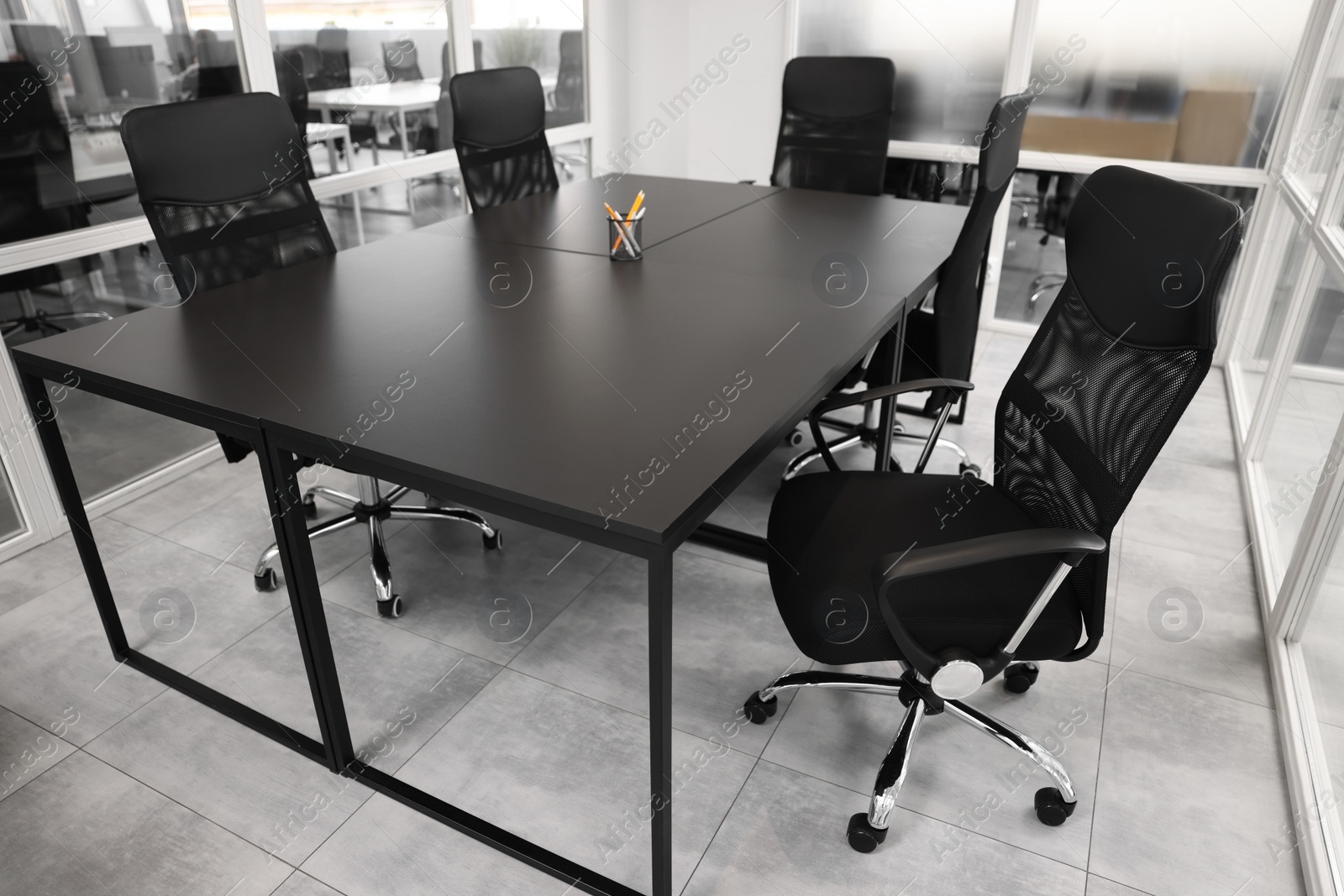 Photo of Comfortable office chairs and tables in meeting room