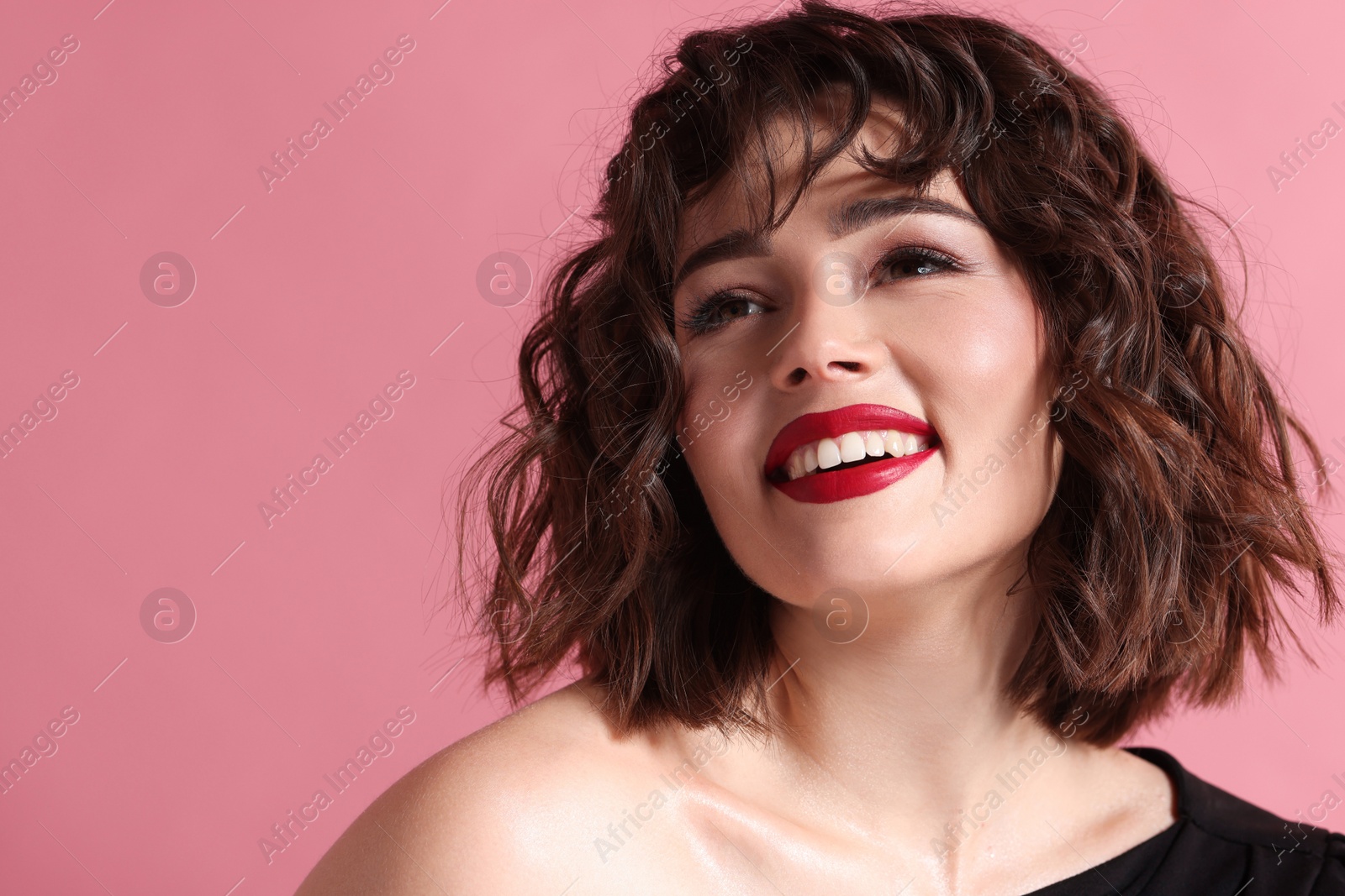 Photo of Portrait of beautiful young woman with wavy hairstyle on pink background. Space for text