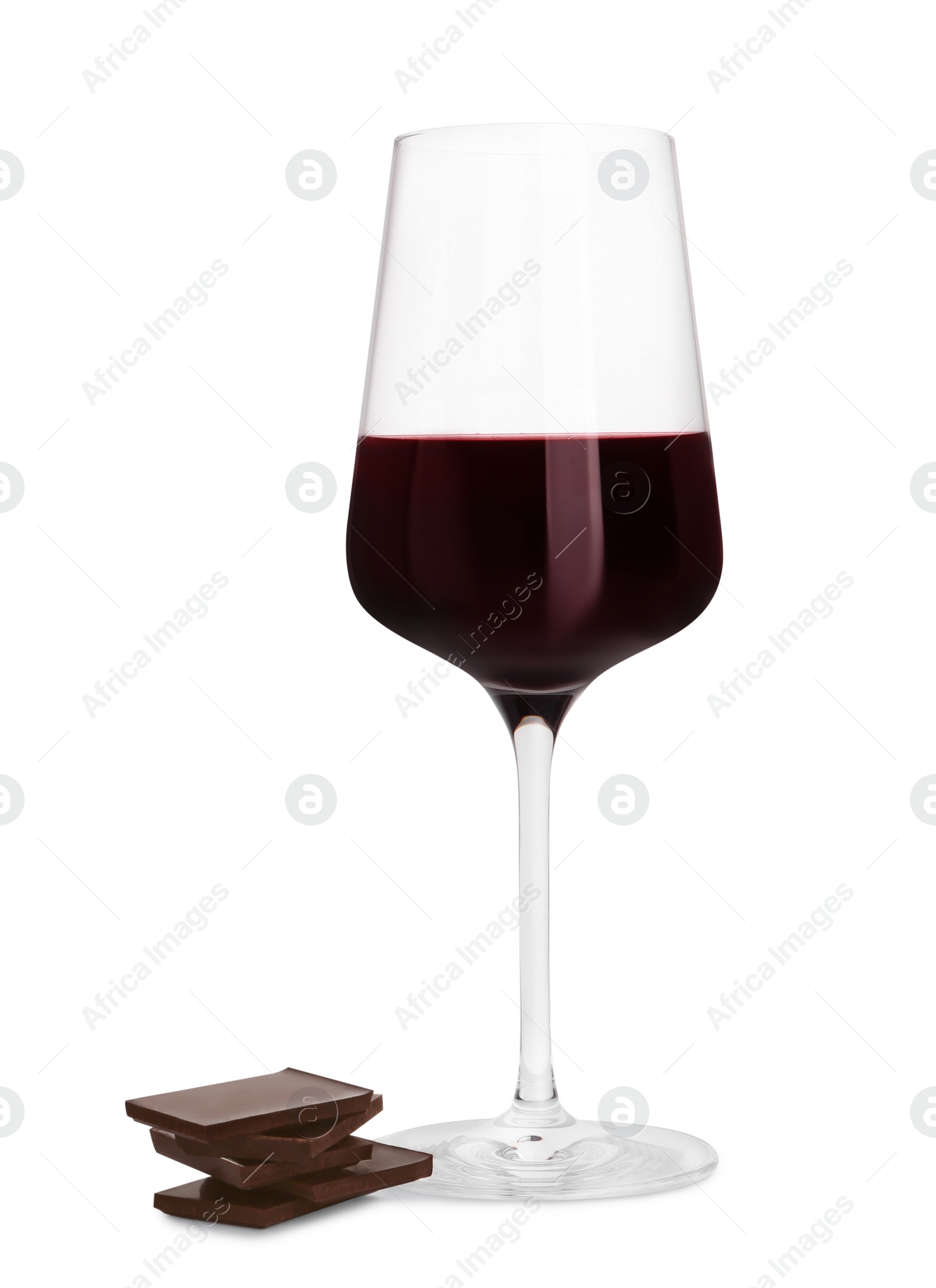 Photo of Glass of red wine and delicious chocolate pieces on white background