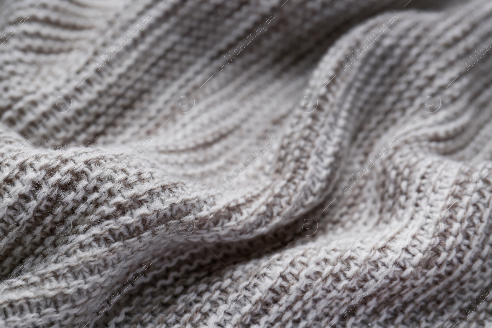 Photo of Beautiful grey knitted fabric as background, closeup