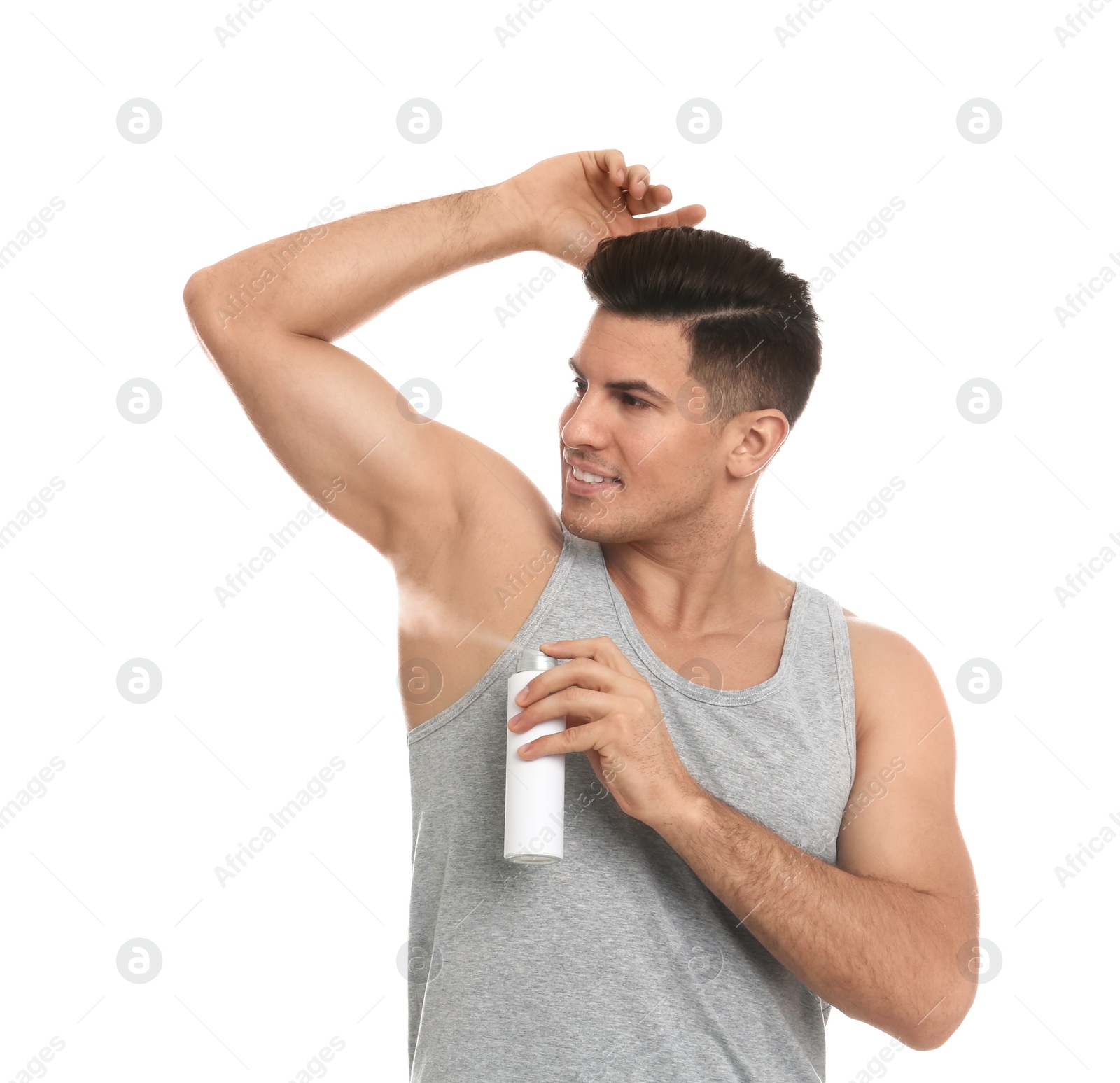 Photo of Handsome man applying deodorant to armpit on white background