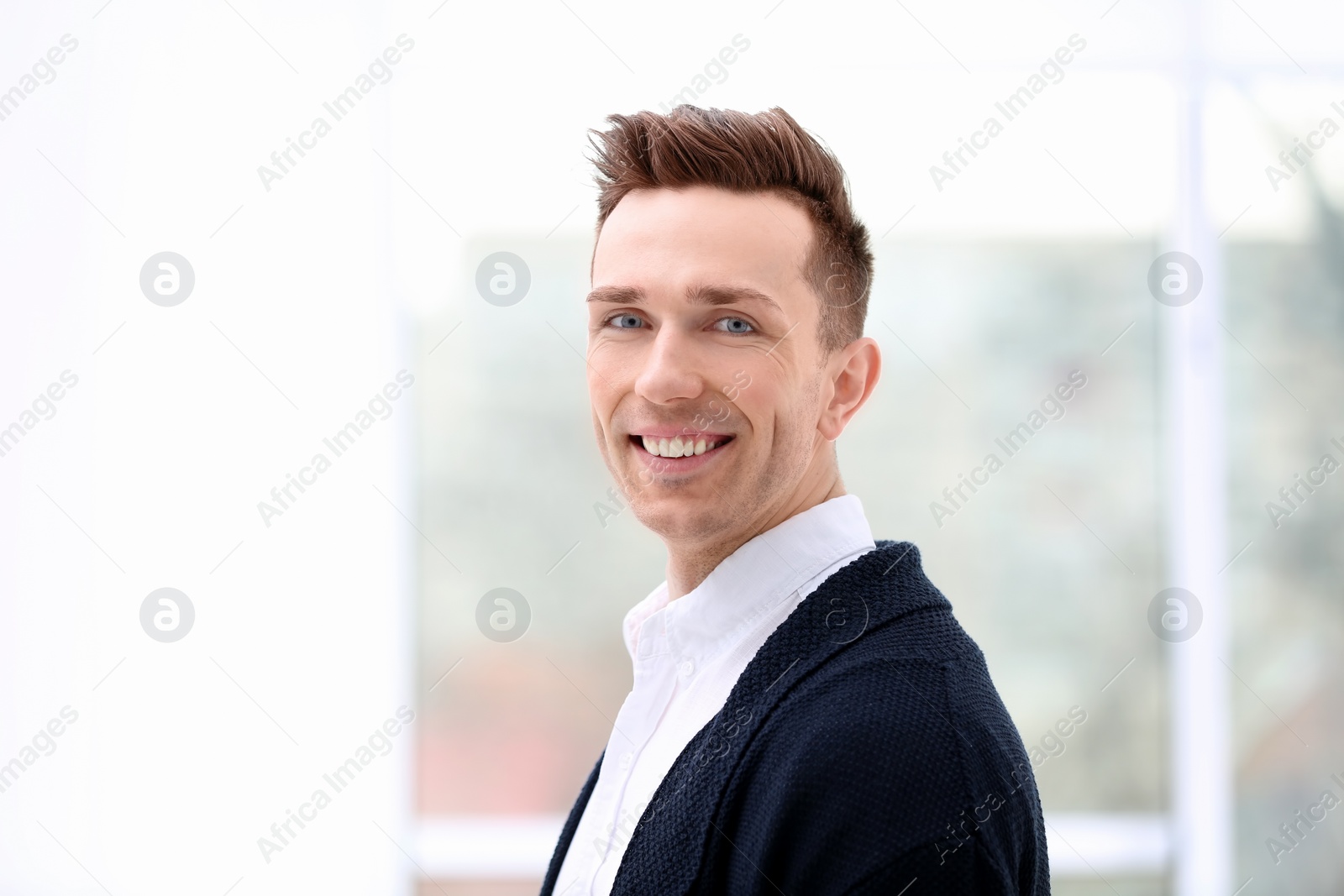 Photo of Young man in casual clothes on blurred background