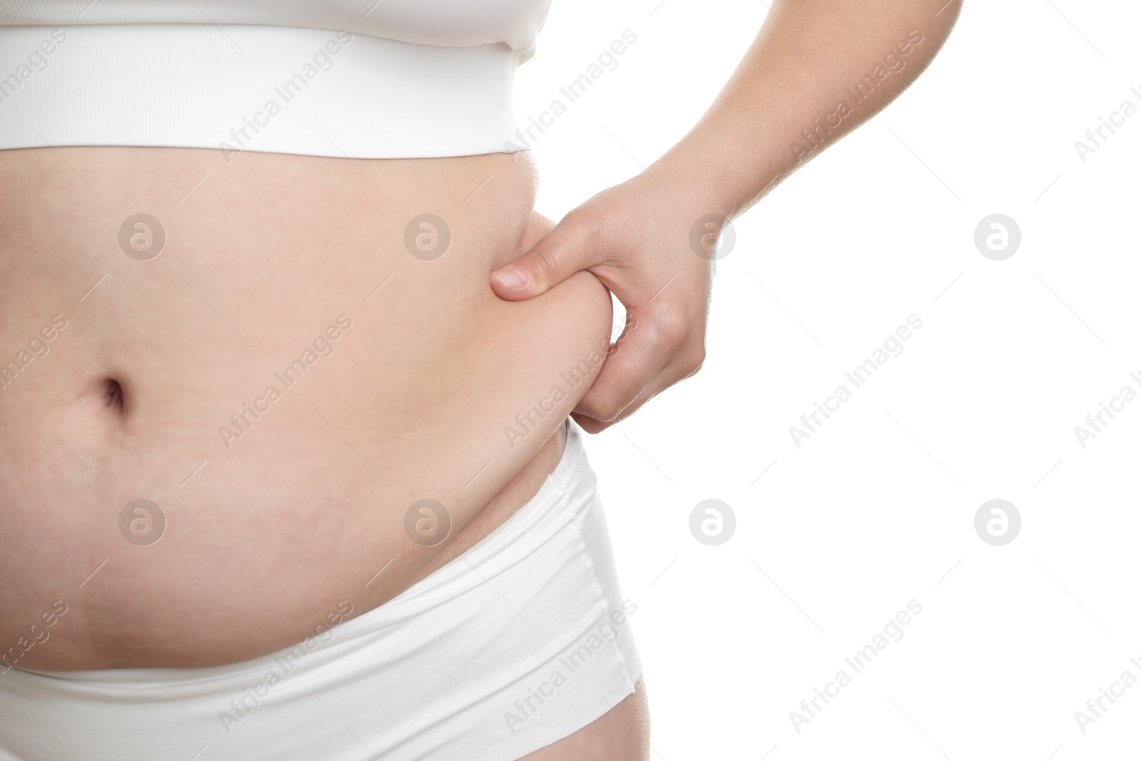 Photo of Woman touching belly fat on white background, closeup. Overweight problem