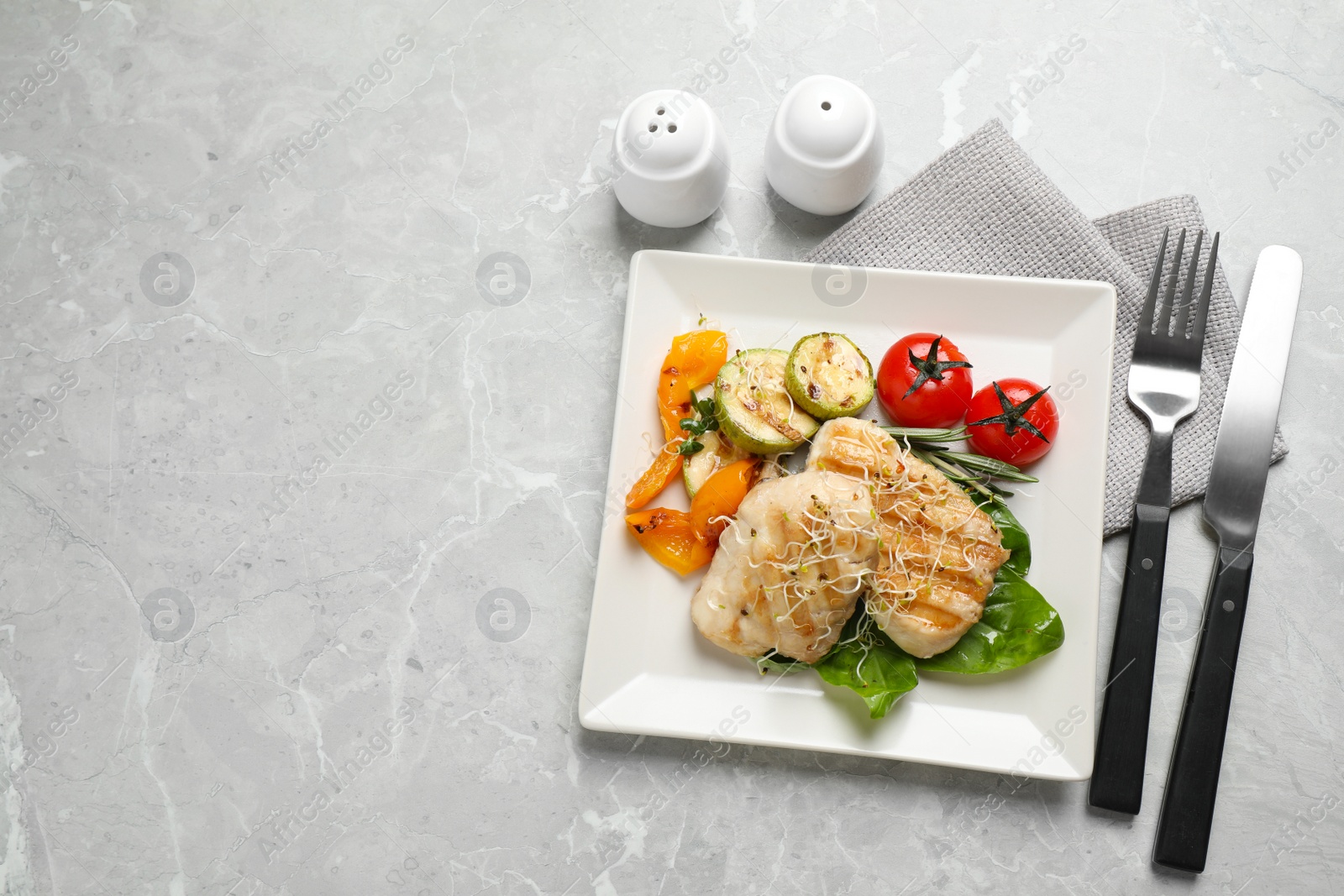 Photo of Flat lay composition with grilled fish on light grey marble table. Space for text