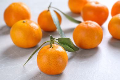 Photo of Tasty fresh ripe tangerines on light table