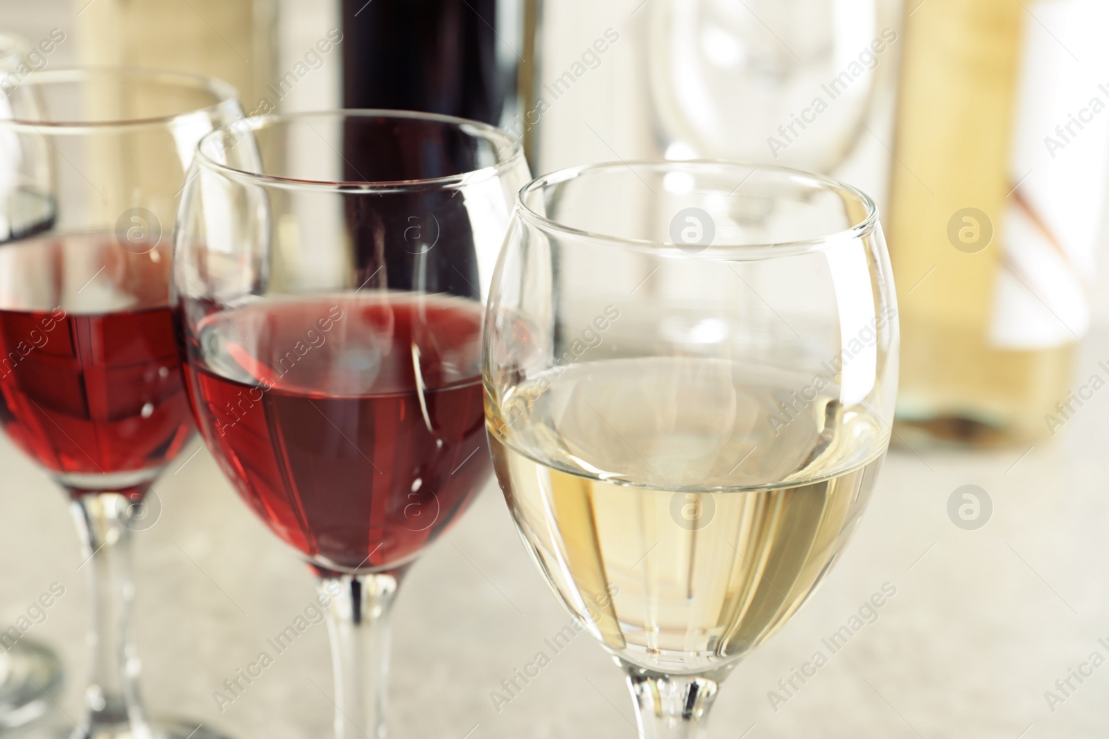 Photo of Elegant glasses with delicious wine on table