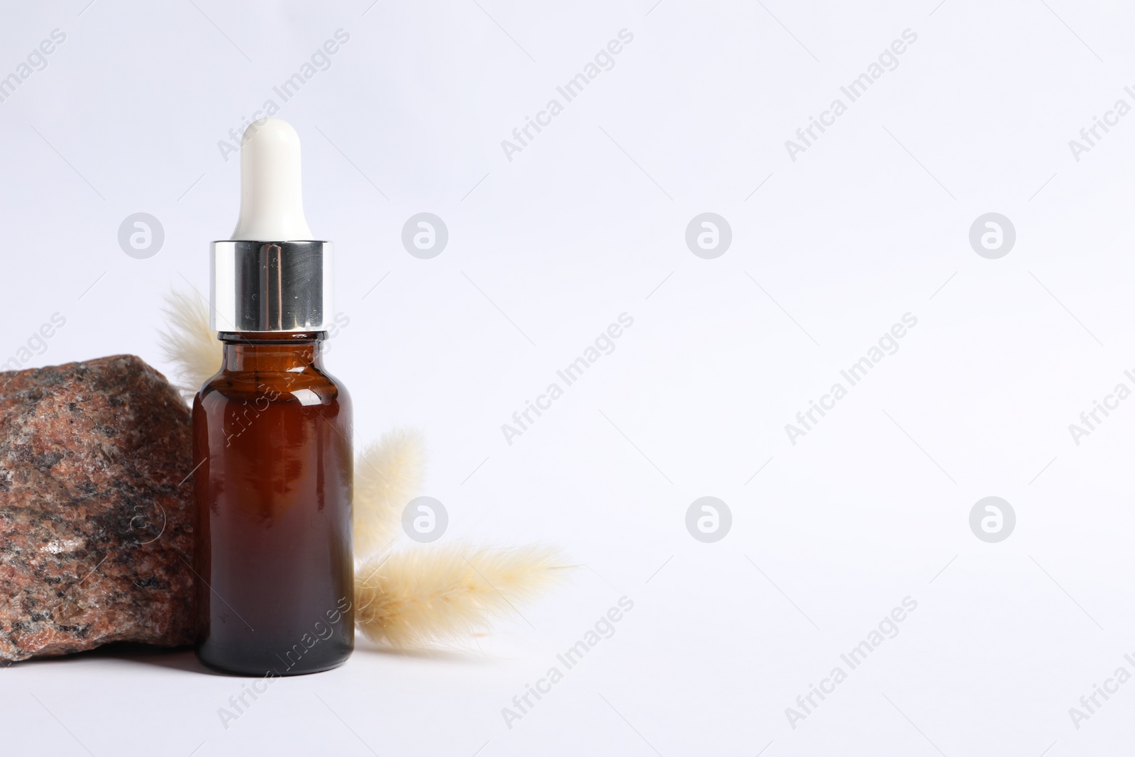 Photo of Composition with bottle of cosmetic serum on white background. Space for text