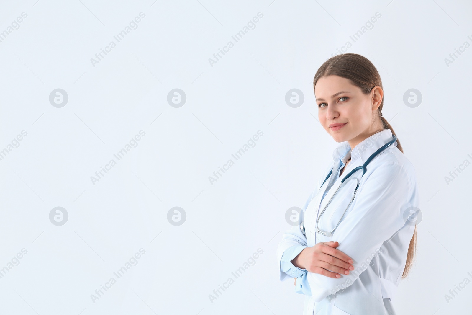 Photo of Portrait of young doctor against white background