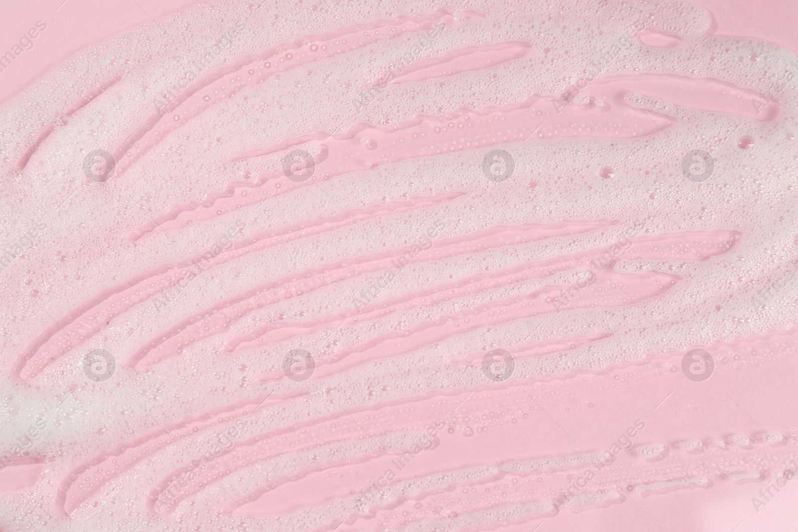 Photo of Cleansing foam on pink background, top view. Cosmetic product