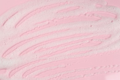 Photo of Cleansing foam on pink background, top view. Cosmetic product