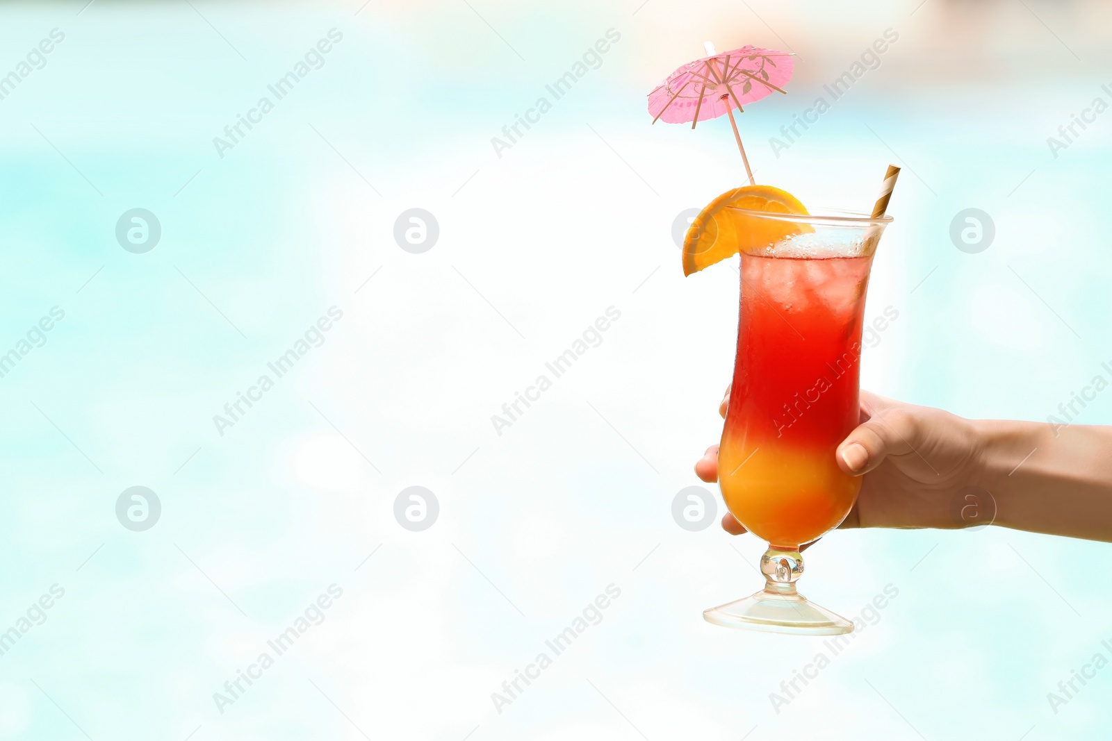 Photo of Woman holding glass with delicious cocktail outdoors