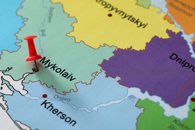 Map of Ukraine with red push pin placed on Mykolaiv, closeup