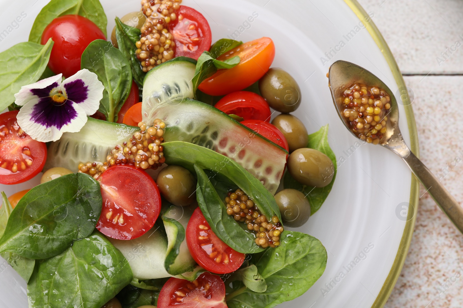 Photo of Delicious salad with vegetables, olives and grain mustard on light table, top view