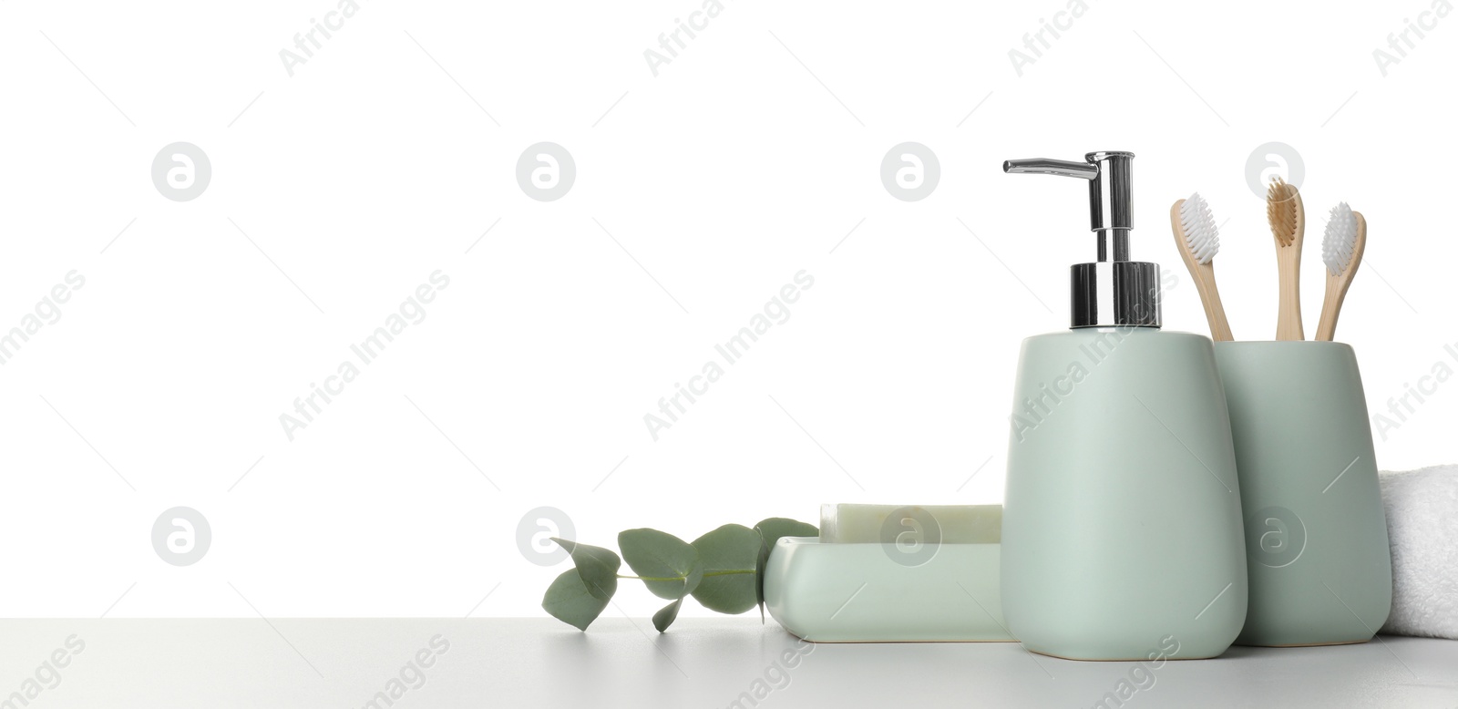 Photo of Bath accessories. Different personal care products and eucalyptus branch on table against white background. Space for text