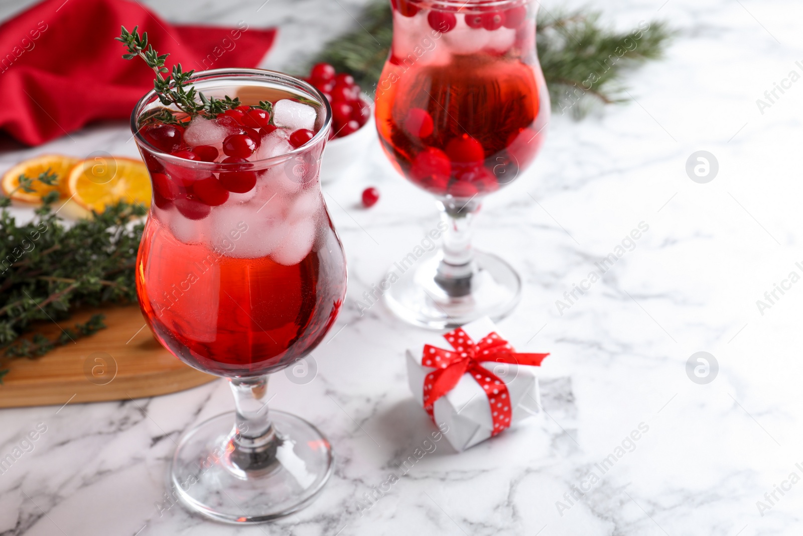 Photo of Delicious Christmas liqueur on white marble table, closeup