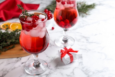 Photo of Delicious Christmas liqueur on white marble table, closeup
