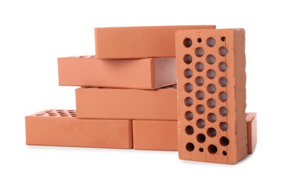 Photo of Many red bricks on white background. Building material