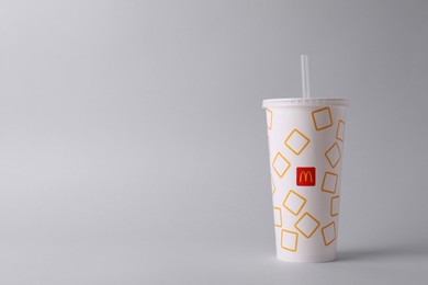 Photo of MYKOLAIV, UKRAINE - AUGUST 12, 2021: Cold McDonald's drink on light background. Space for text