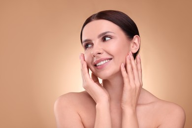Photo of Beautiful woman with healthy skin on light brown background, space for text. Body Care
