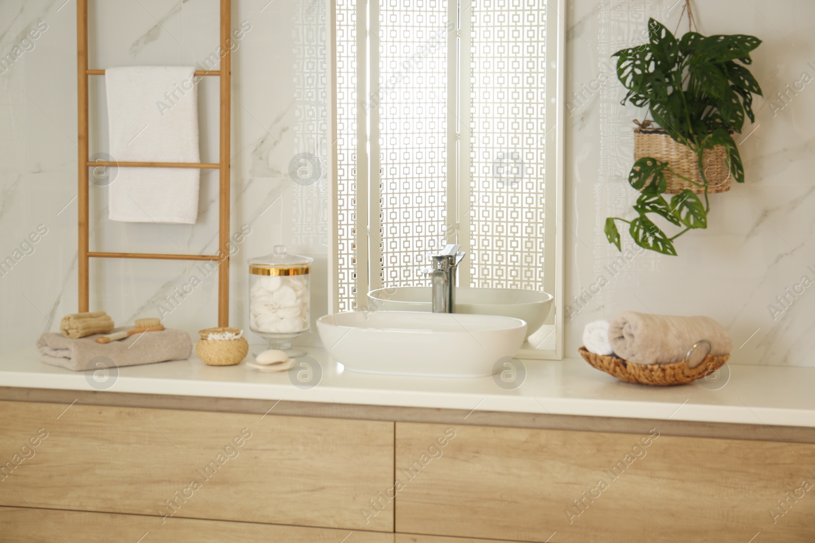 Photo of Large mirror and vessel sink in stylish bathroom