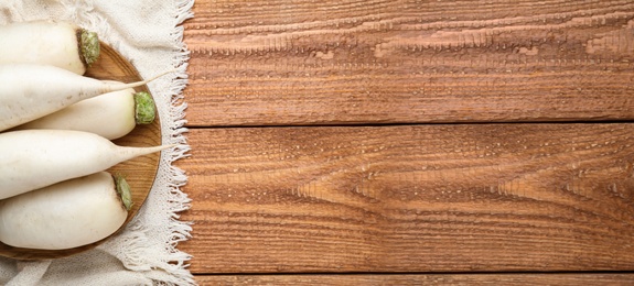 Image of White turnips on wooden table, flat lay. Space for text