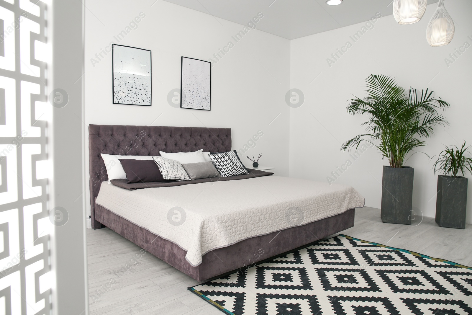 Photo of Elegant interior of modern comfortable bedroom with green plants