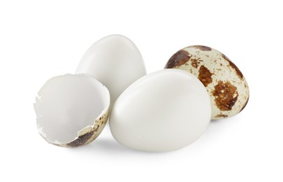 Photo of Unpeeled and peeled boiled quail eggs on white background
