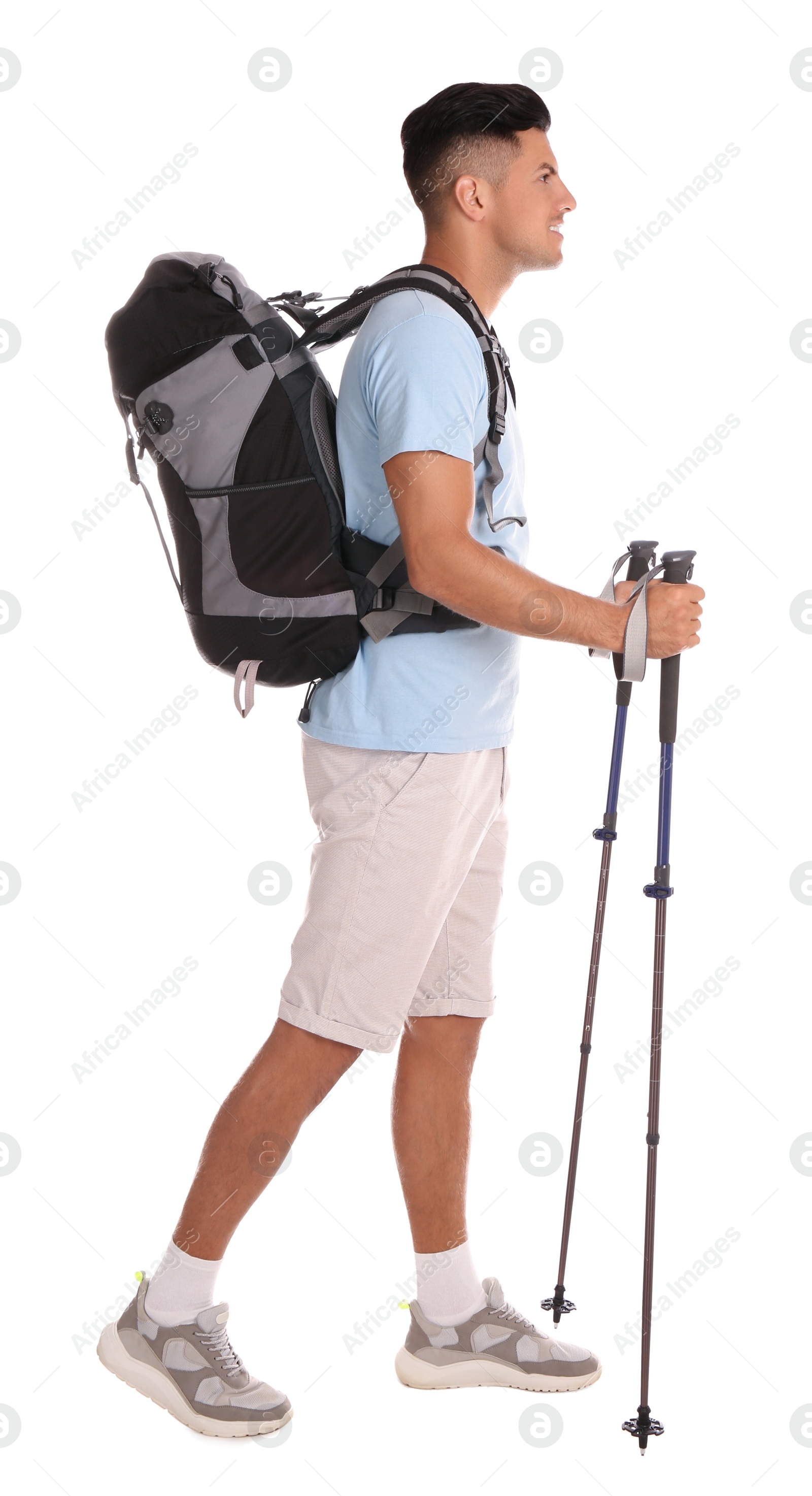 Photo of Male hiker with backpack and trekking poles on white background