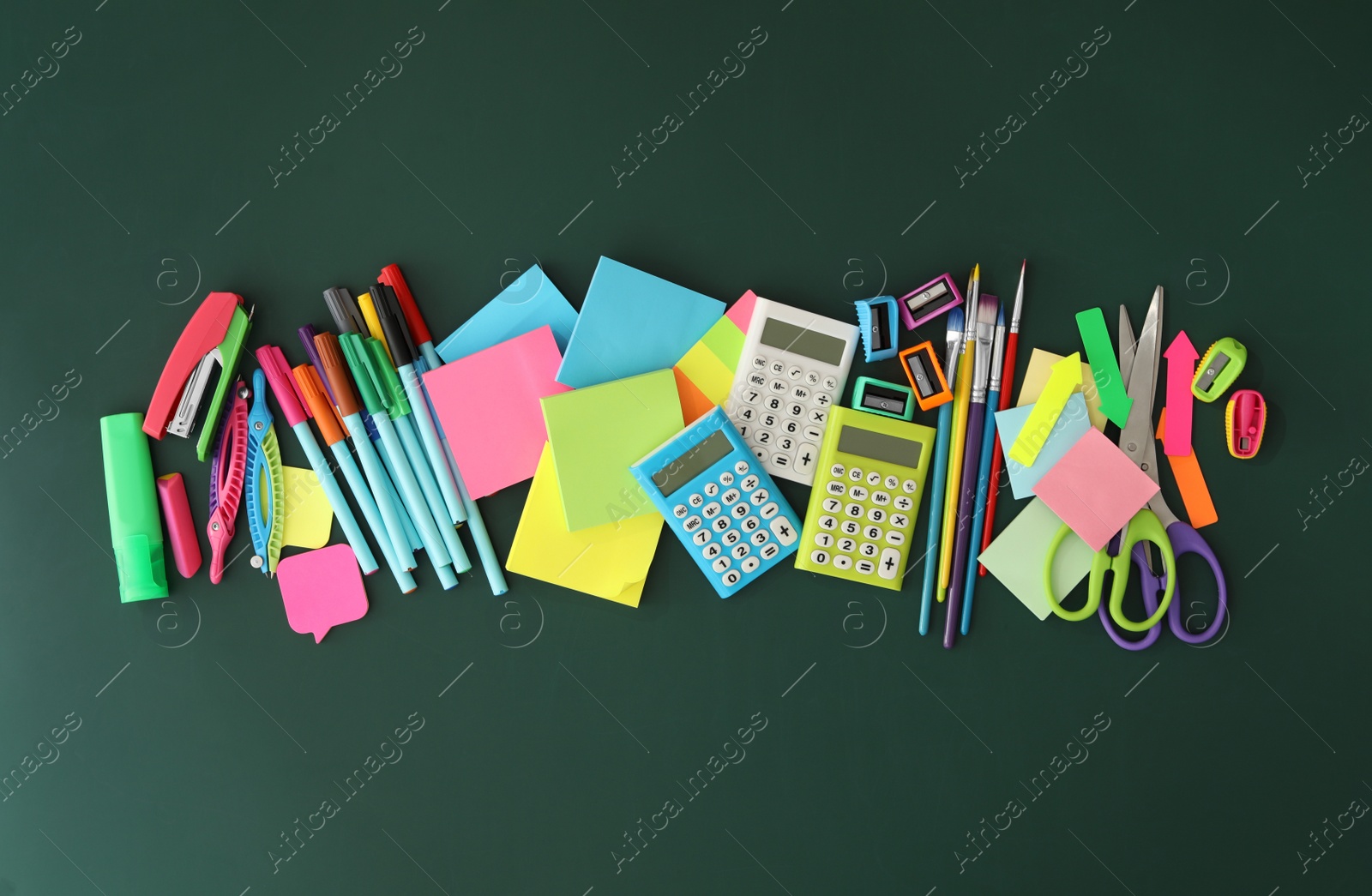 Photo of Flat lay composition with different school stationery on green chalkboard. Back to school