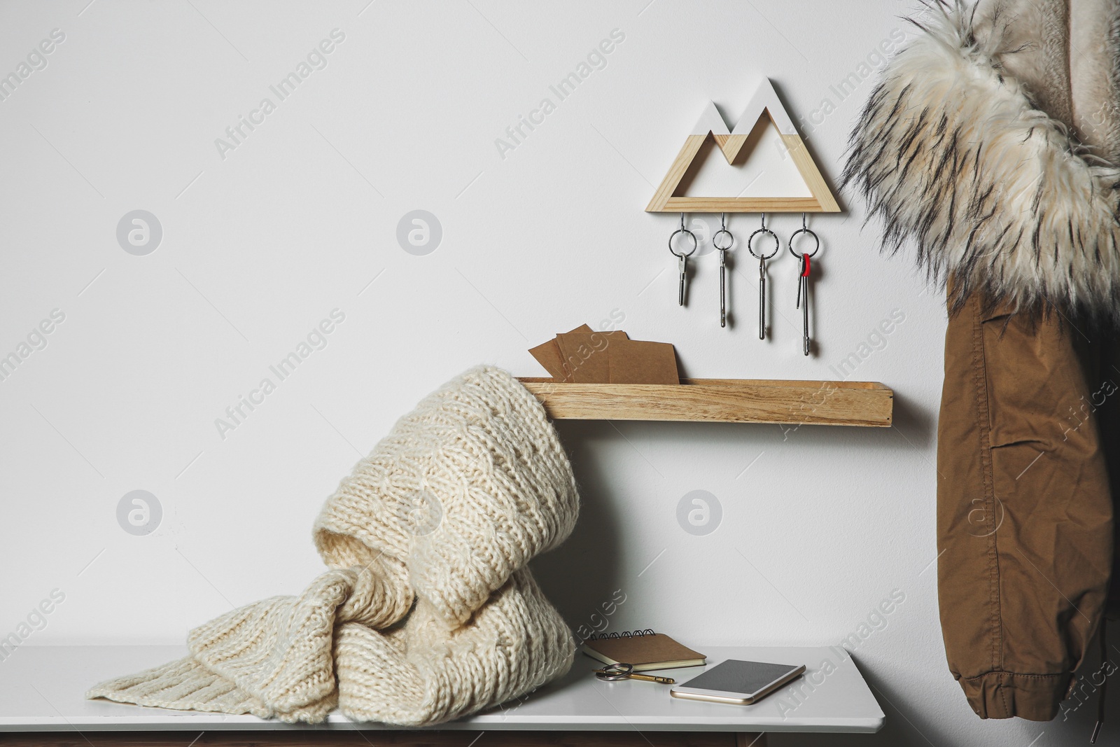 Photo of Wooden key holder on light wall indoors