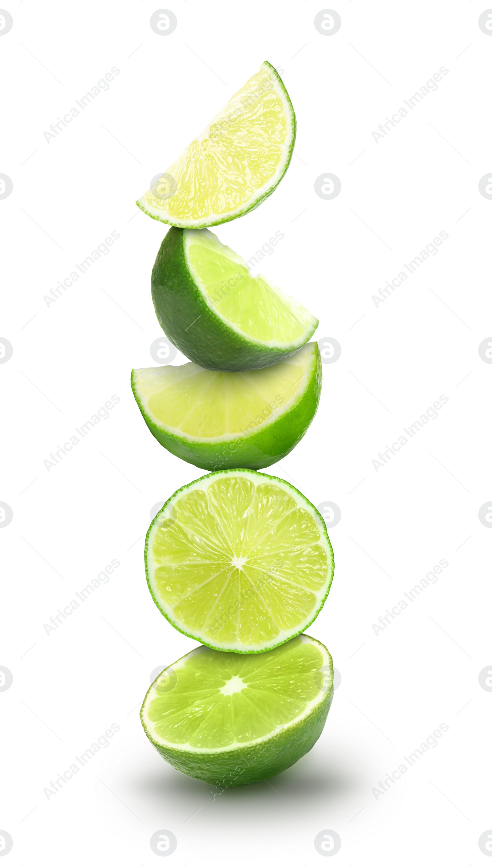 Image of Many stacked cut limes on white background