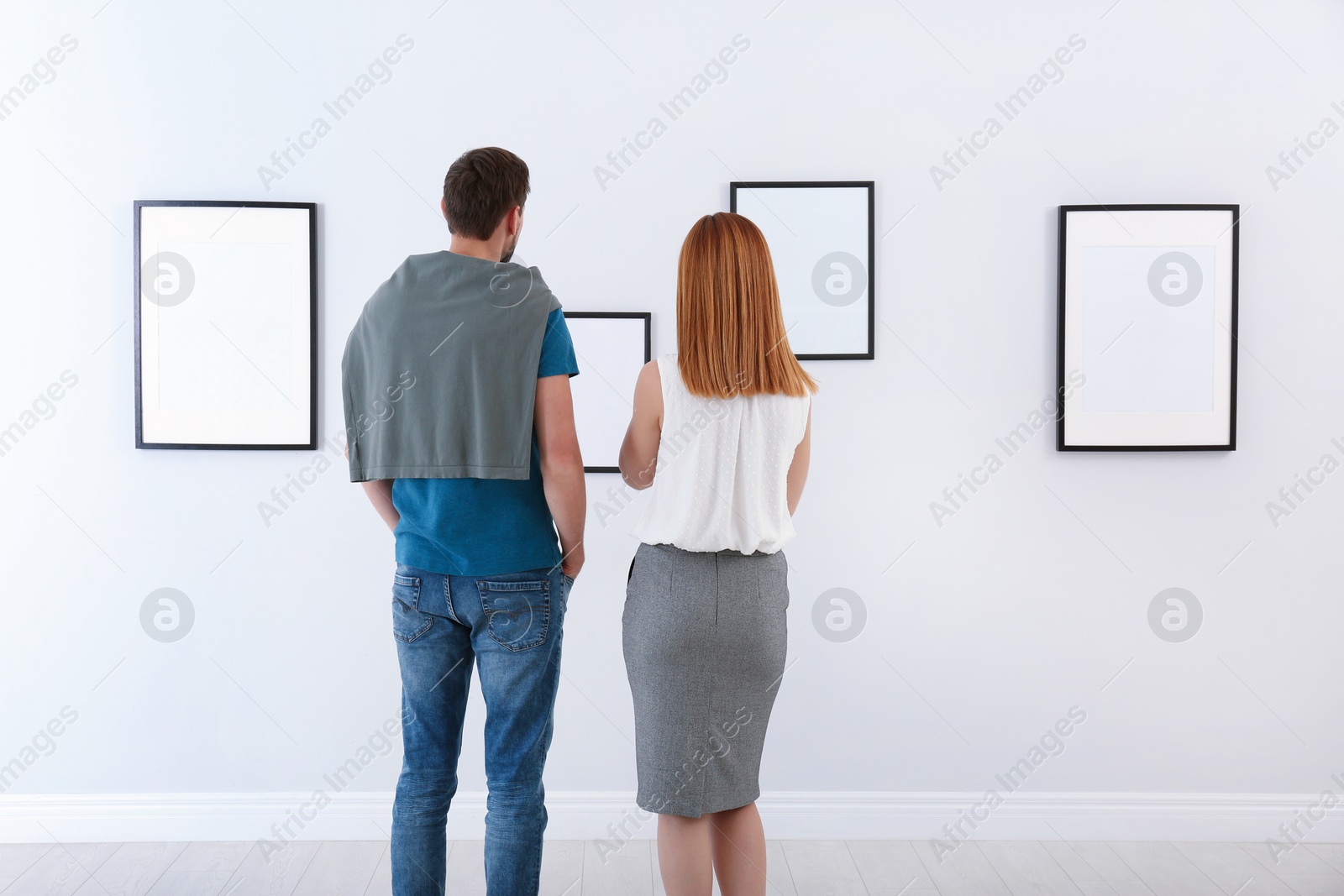 Photo of People viewing exposition in modern art gallery