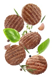 Tasty grilled hamburger patties and spices falling on white background