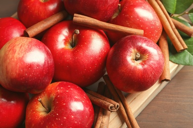 Photo of Fresh apples and cinnamon sticks, closeup