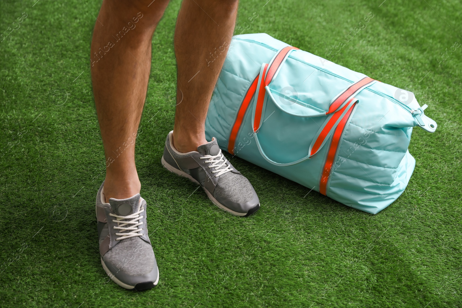 Photo of Man standing with sports bag, closeup view