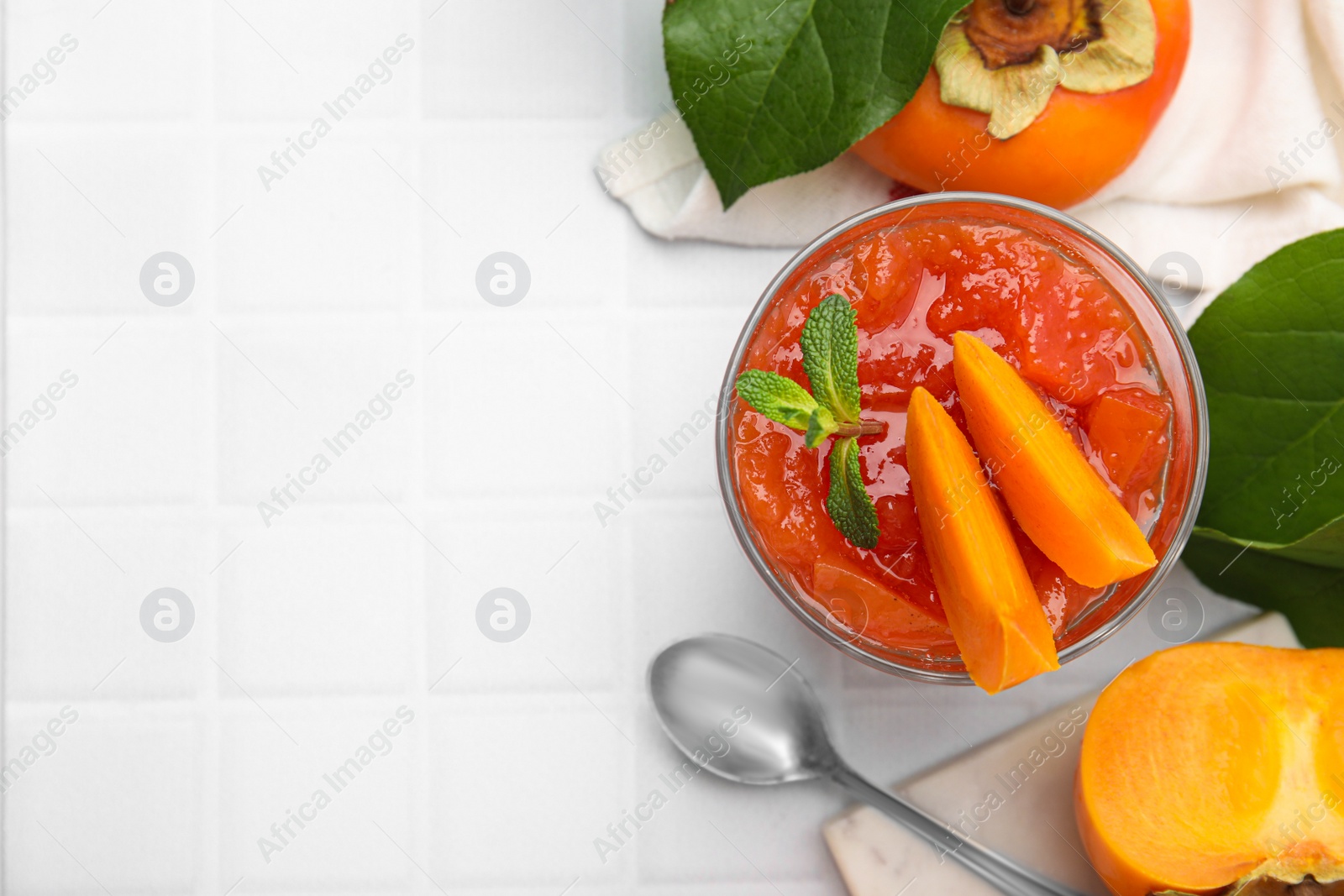 Photo of Delicious dessert with persimmon on table, flat lay. Space for text