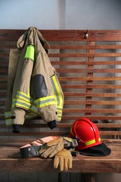 Photo of Firefighter`s uniform, helmet, gloves and mask at station