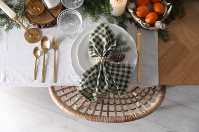 Photo of Christmas table setting with festive decor and dishware, top view