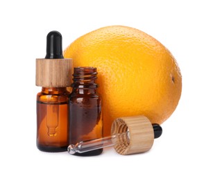 Bottles of citrus essential oil and fresh orange isolated on white