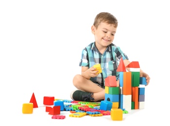 Photo of Little child playing with blocks on white background. Indoor recreation