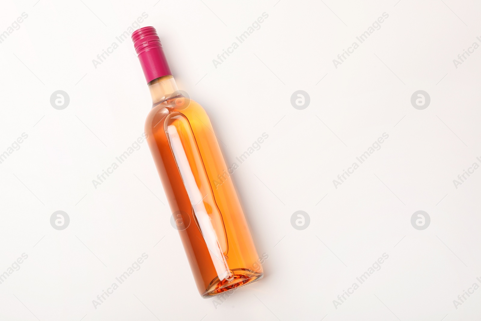 Photo of Bottle of expensive rose wine on white background, top view. Space for text