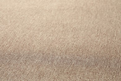 Photo of Texture of light brown fabric as background, closeup