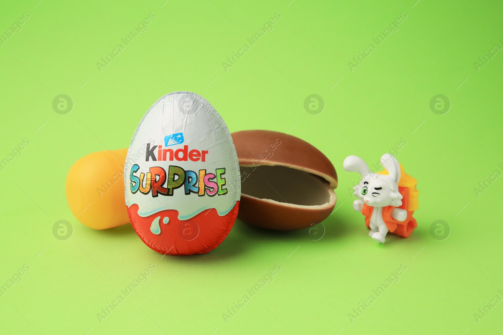 Photo of Sveti Vlas, Bulgaria - June 29, 2023: Kinder Surprise Eggs, plastic capsule and toy bunny on light green background