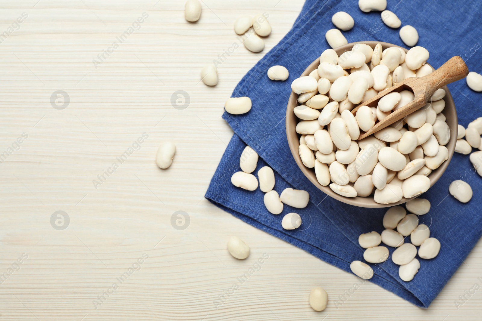Photo of Raw beans on white wooden table, flat lay. Space for text